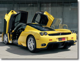 Yellow Ferrari shown with doors open