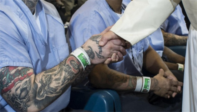Pope Francis shakes the hand of tattooed inmate at a prison in Philadelphia on Sept 27, 2015